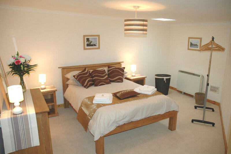 Spacious bedroom with wool carpet and solid oak furniture