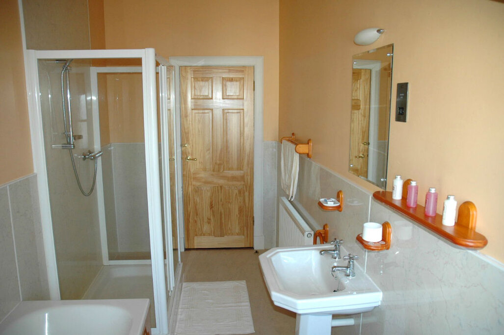 Bathroom with large shower cubicle and separate bath Bathroom with large shower cubicle and separate bath