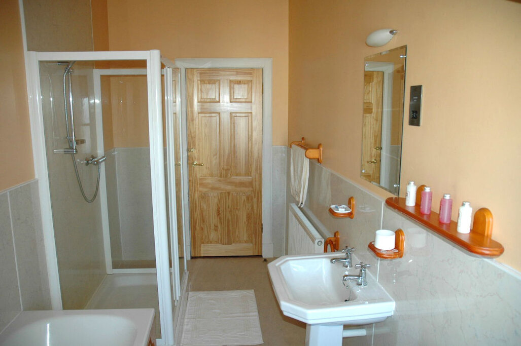 Bathroom with large shower cubicle and separate bath
